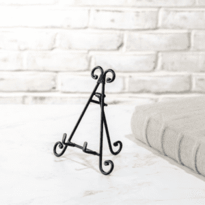 Elegant black metal easel stand on a white surface.